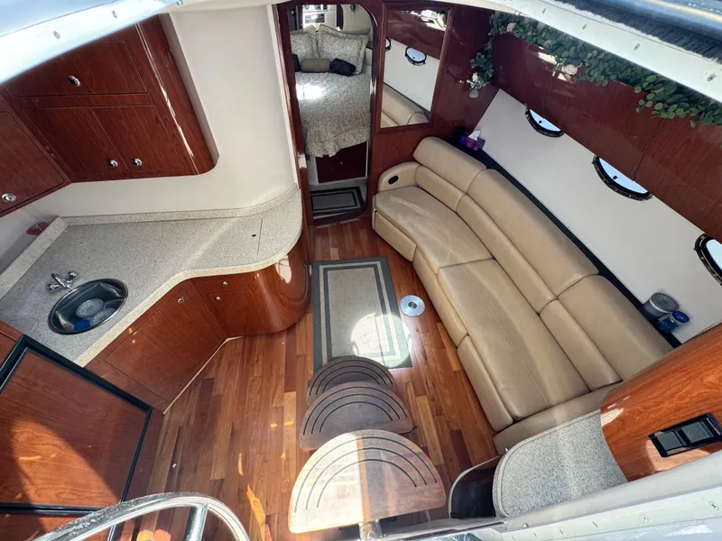 Slide: The Image of Luxurious interior of 2009 Regal Commodore 4060 yacht with beige leather seating and wood accents. - 18