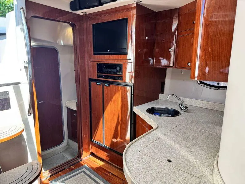 Slide: The Image of Interior of 2009 Regal Commodore 4060 yacht with wooden cabinetry and door. - 25