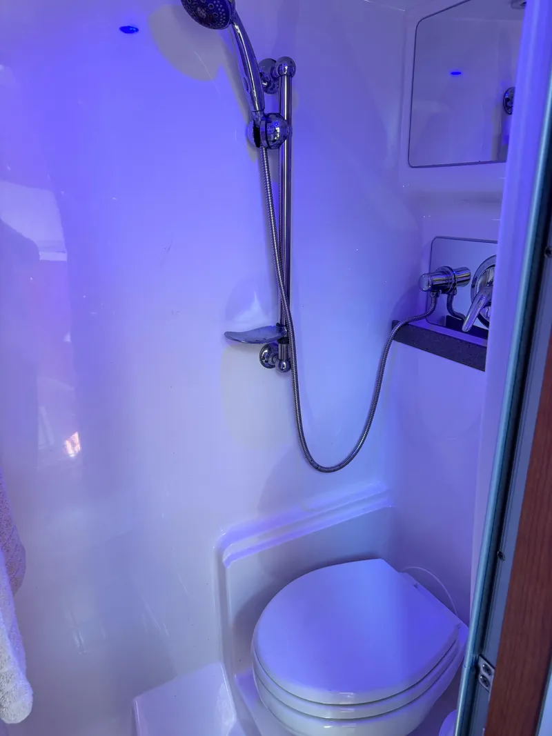 Slide: The Image of Shower area in 2009 Regal Commodore 4060 boat with modern fixtures and blue lighting. - 27