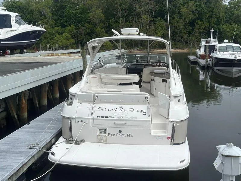 Slide: The Image of 2009 Regal Commodore 4060 yacht cruising on blue ocean near scenic coastline. - 3