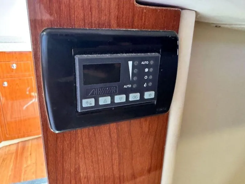 Slide: The Image of 2009 Regal Commodore 4060 cabin interior with cozy lighting and wooden storage. - 30