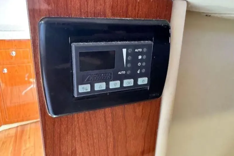 Slide: The Image of Control panel on 2009 Regal Commodore 4060 yacht, mounted on wooden interior. - 32