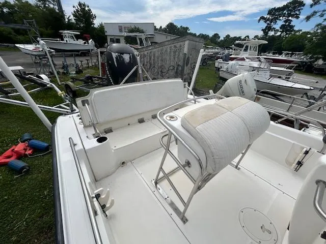 Slide: The Image of 2005 Boston Whaler 220 Dauntless boat interior with seating and equipment, docked outdoors. - 12