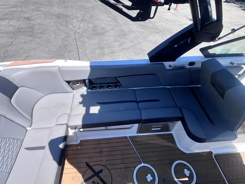 Slide: The Image of 2022 MasterCraft X26 boat interior with sleek seating and modern design. - 11