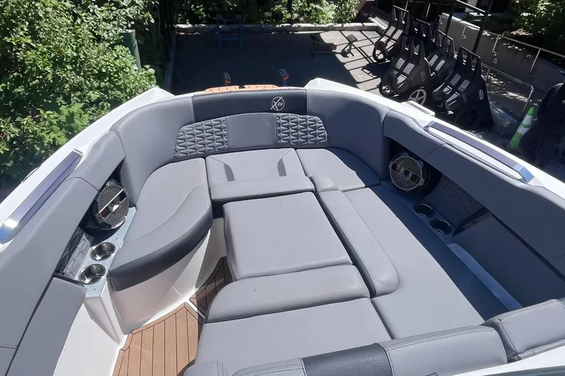 Slide: The Image of Luxurious seating area on a 2022 MasterCraft X26 boat, featuring sleek gray upholstery. - 13