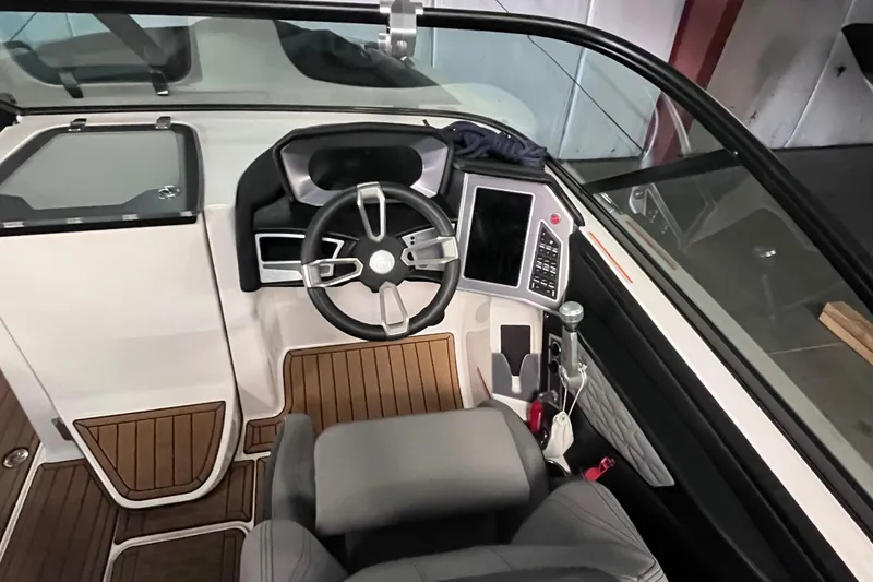 Slide: The Image of 2022 MasterCraft X26 boat cockpit with modern steering and controls. - 15