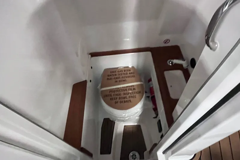 Slide: The Image of 2022 MasterCraft X26 boat interior with compact bathroom and sink. - 16