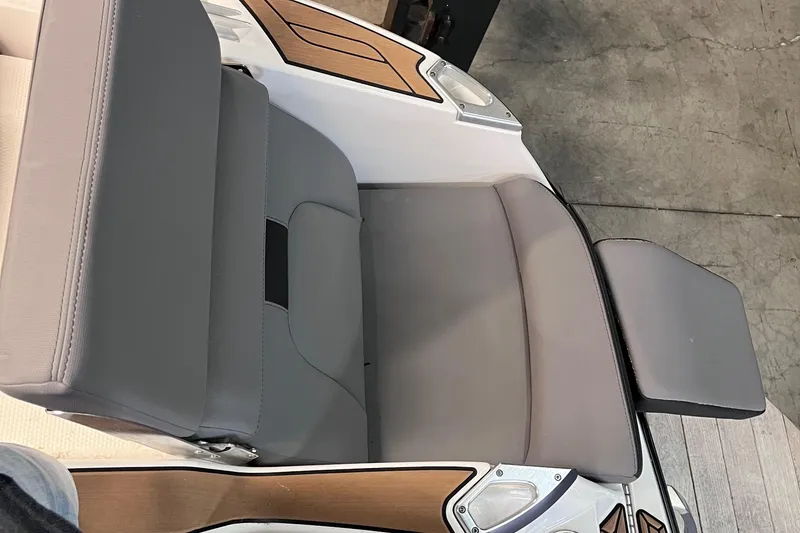 Slide: The Image of 2022 MasterCraft X26 boat seat with gray upholstery and wooden accents. - 20