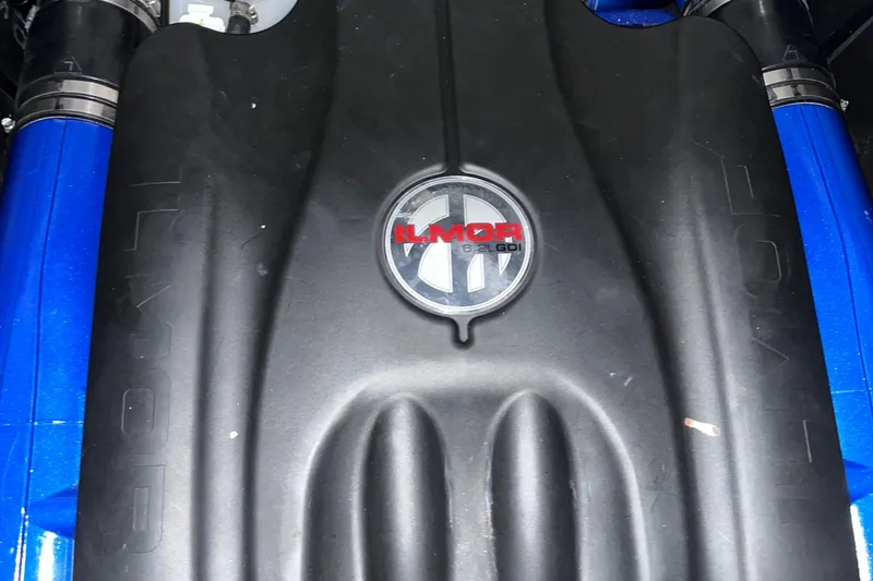 Slide: The Image of 2022 MasterCraft X26 engine cover with Ilmor branding, showcasing sleek design and performance. - 21