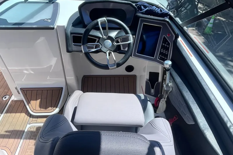 Slide: The Image of 2022 MasterCraft X26 boat cockpit with modern steering and control panel. - 6