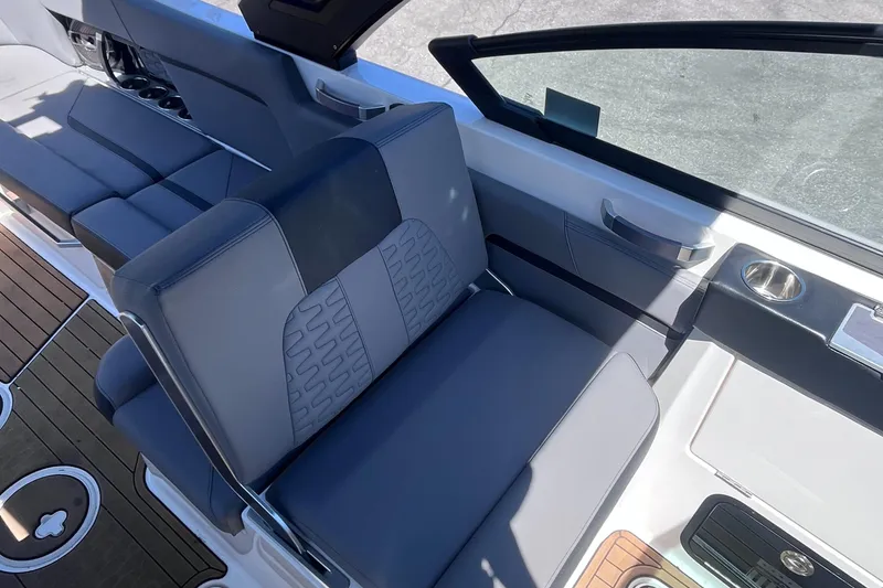 Slide: The Image of 2022 MasterCraft X26 boat interior with sleek seating and modern design. - 7