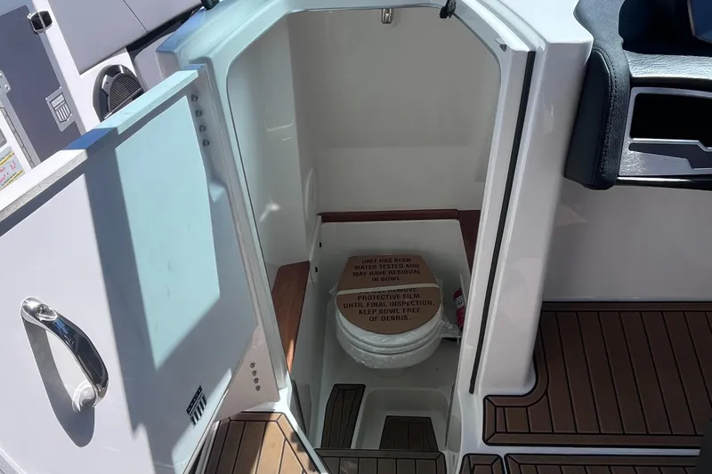Slide: The Image of 2022 MasterCraft X26 boat interior with compact bathroom and toilet. - 8