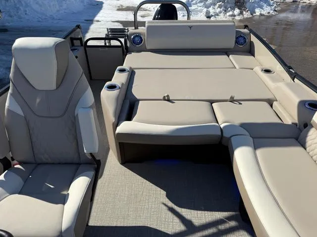 Slide: The Image of 2025 Tahoe Cascade 2385 Versatile Rear Lounger with beige seating and cup holders. - 11