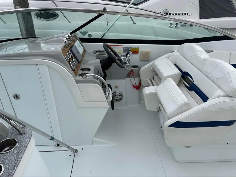 Slide: The Image of 2009 Formula 310 Bowrider I/O boat interior with steering wheel and seating area. - 6