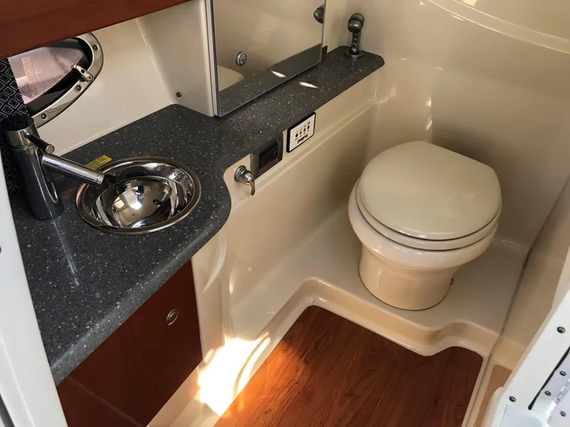 Slide: The Image of 2009 Formula 310 Bowrider I/O boat bathroom with sink, toilet, and countertop. - 7