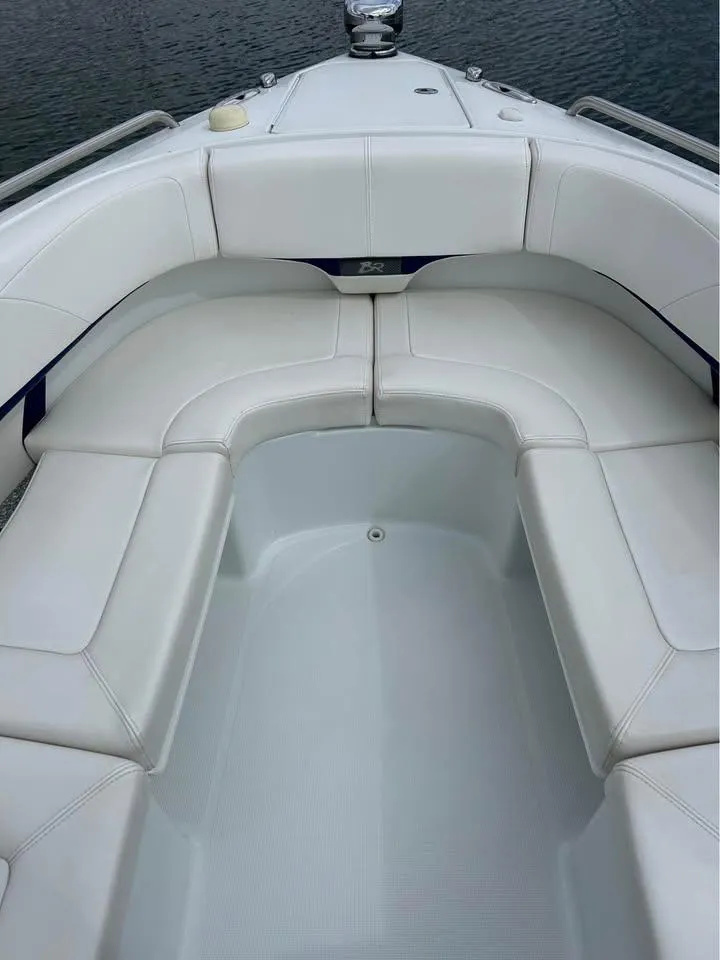 Slide: The Image of 2009 Formula 310 Bowrider I/O with white seating, spacious deck, and sleek design. - 8