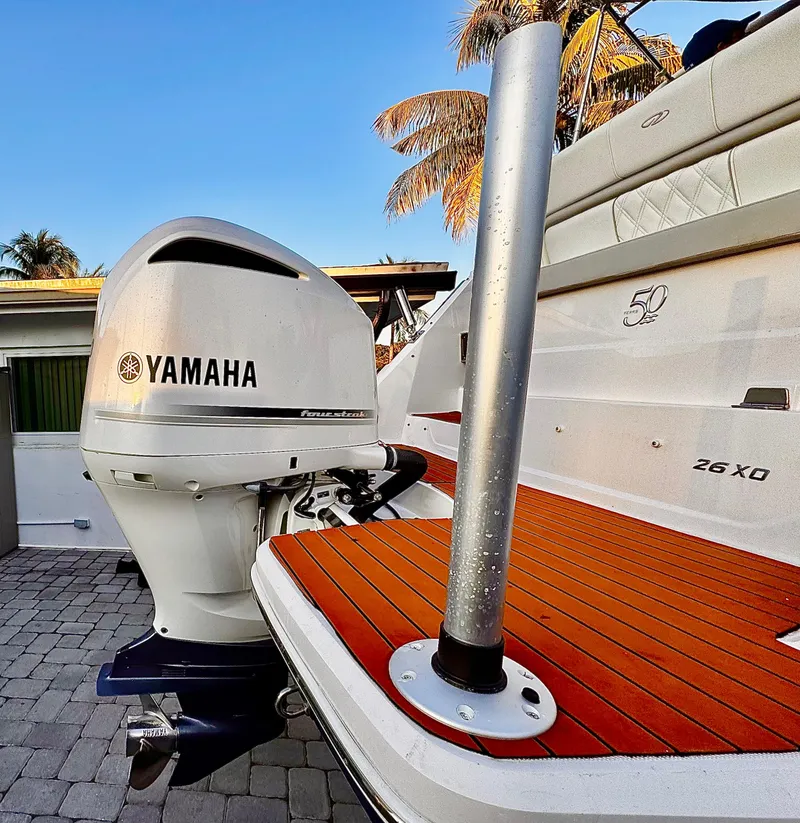 Slide: The Image of 2020 Regal 26XO boat with Yamaha outboard motor, docked on a sunny day. - 10