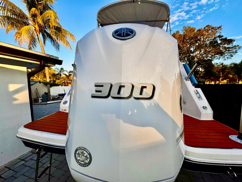 Slide: The Image of 2020 Regal 26XO boat with 300 horsepower engine, docked under clear blue sky. - 11