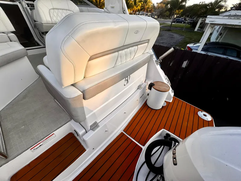 Slide: The Image of 2020 Regal 26XO boat interior with white seating and teak flooring. - 13