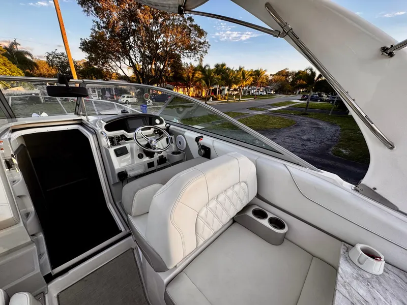 Slide: The Image of 2020 Regal 26XO boat interior with white seating and steering console. - 15