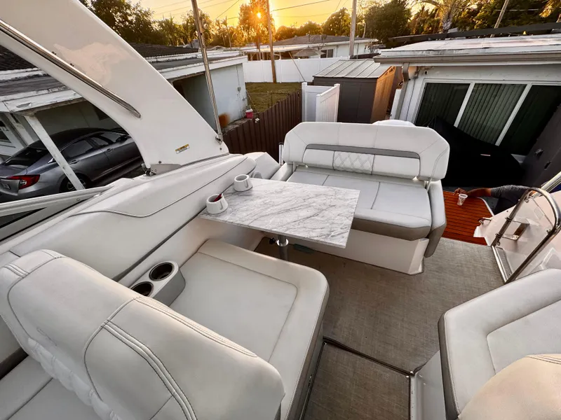 Slide: The Image of Luxurious 2020 Regal 26XO boat interior with elegant seating and marble table at sunset. - 18