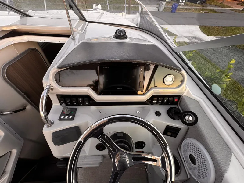 Slide: The Image of Cockpit of a 2020 Regal 26XO boat with steering wheel and control panel. - 20