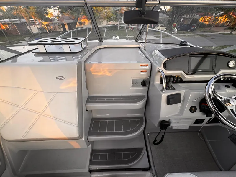 Slide: The Image of 2020 Regal 26XO boat interior with helm, seating, and steps. - 22