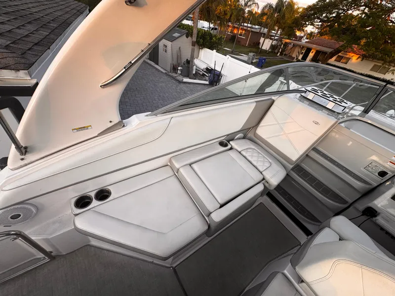 Slide: The Image of 2020 Regal 26XO boat interior with white seating and cup holders. - 26