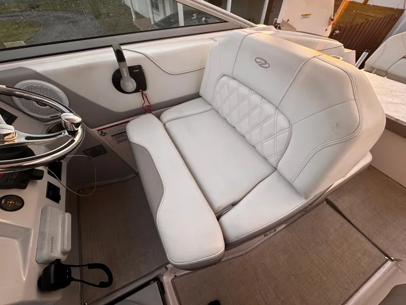 Slide: The Image of 2020 Regal 26XO boat interior with white leather seating and steering wheel. - 29