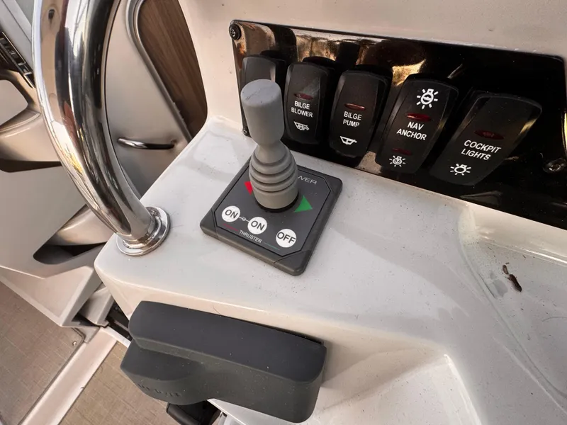 Slide: The Image of Control panel of a 2020 Regal 26XO boat with joystick and switches. - 32