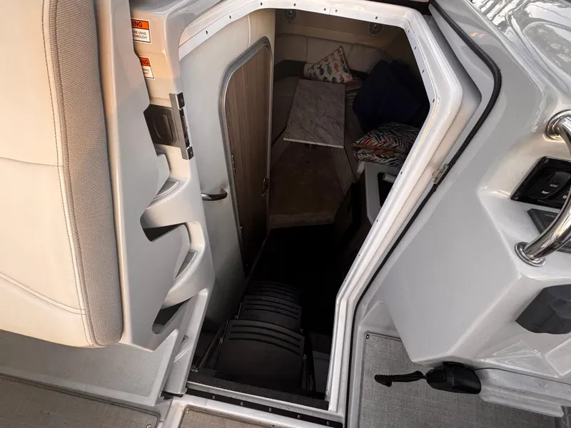 Slide: The Image of Interior cabin view of a 2020 Regal 26XO boat, showing stairs and cozy sleeping area. - 42