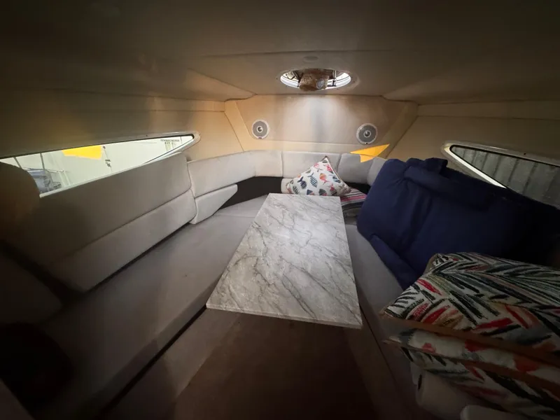 Slide: The Image of Interior of 2020 Regal 26XO boat with cozy seating and cushions. - 43