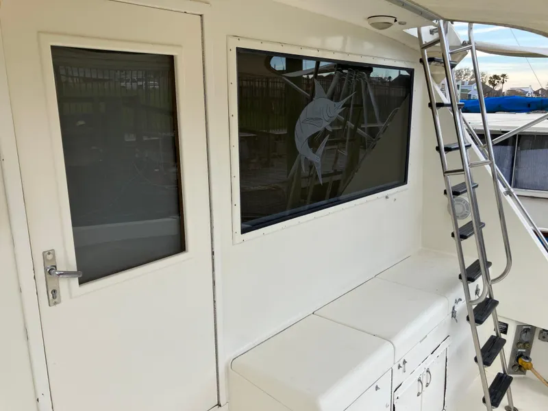 Slide: The Image of 1988 Hatteras 55 Convertible yacht deck with ladder and door. - 13