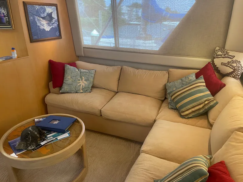 Slide: The Image of Cozy interior of 1988 Hatteras 55 Convertible yacht with beige sofa and colorful cushions. - 15