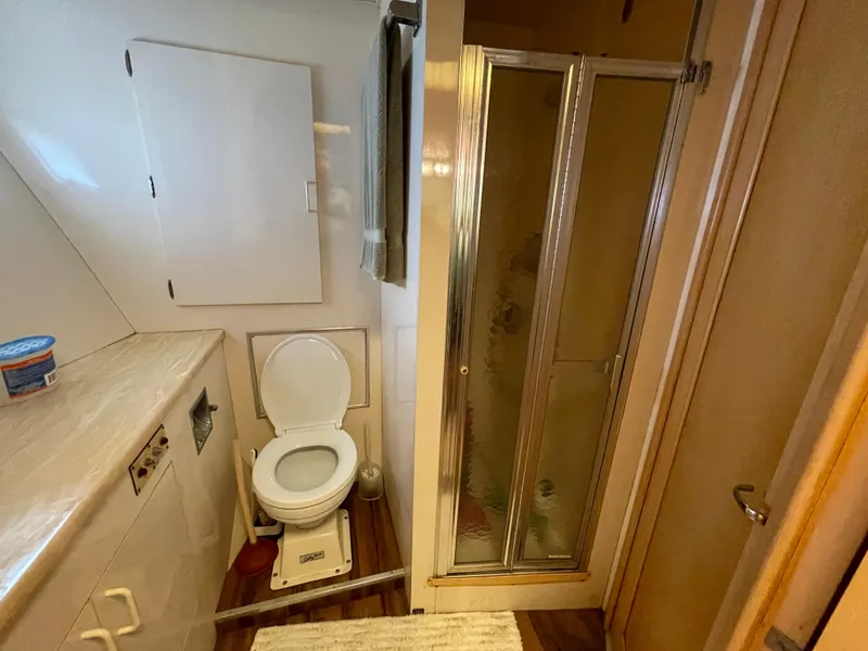 Slide: The Image of Bathroom interior of 1988 Hatteras 55 Convertible yacht with shower and toilet. - 16