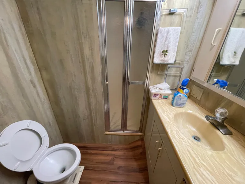 Slide: The Image of Bathroom interior of 1988 Hatteras 55 Convertible yacht with shower, sink, and toilet. - 18