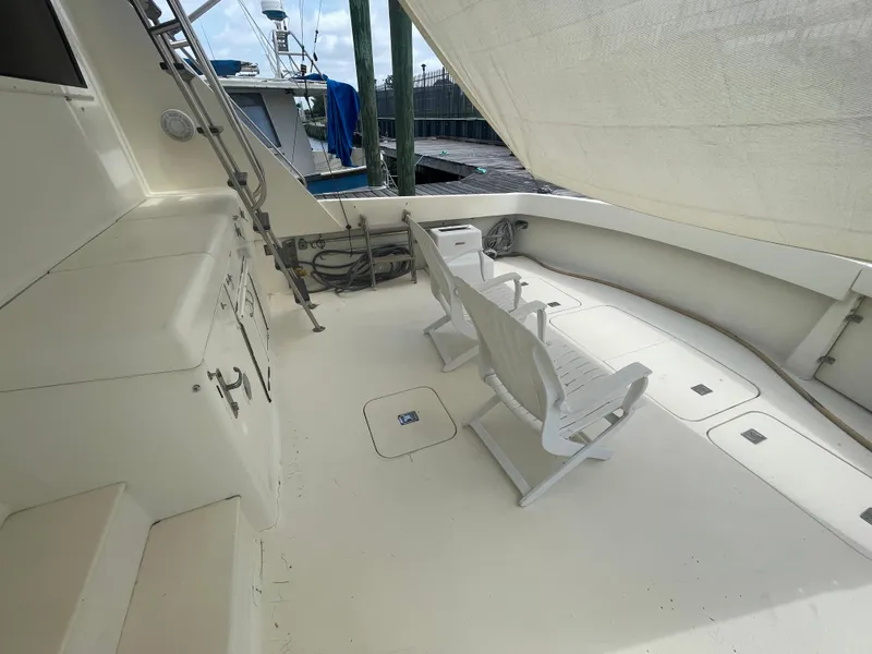 Slide: The Image of 1988 Hatteras 55 Convertible yacht deck with seating and canopy. - 19