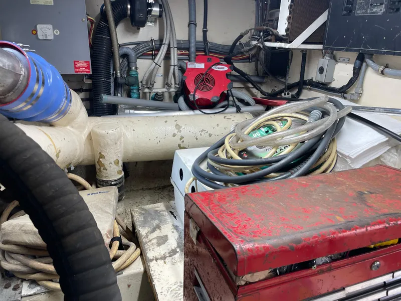 Slide: The Image of Engine room of a 1988 Hatteras 55 Convertible with tools and cables. - 24