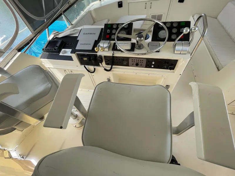 Slide: The Image of 1988 Hatteras 55 Convertible yacht helm with Garmin navigation equipment and dual captain chairs. - 25