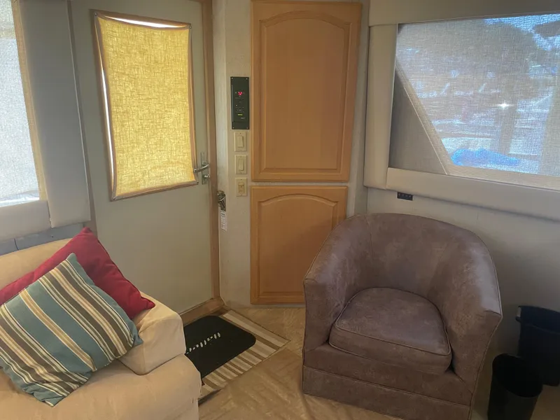 Slide: The Image of Interior of 1988 Hatteras 55 Convertible yacht with cozy seating and window shades. - 27