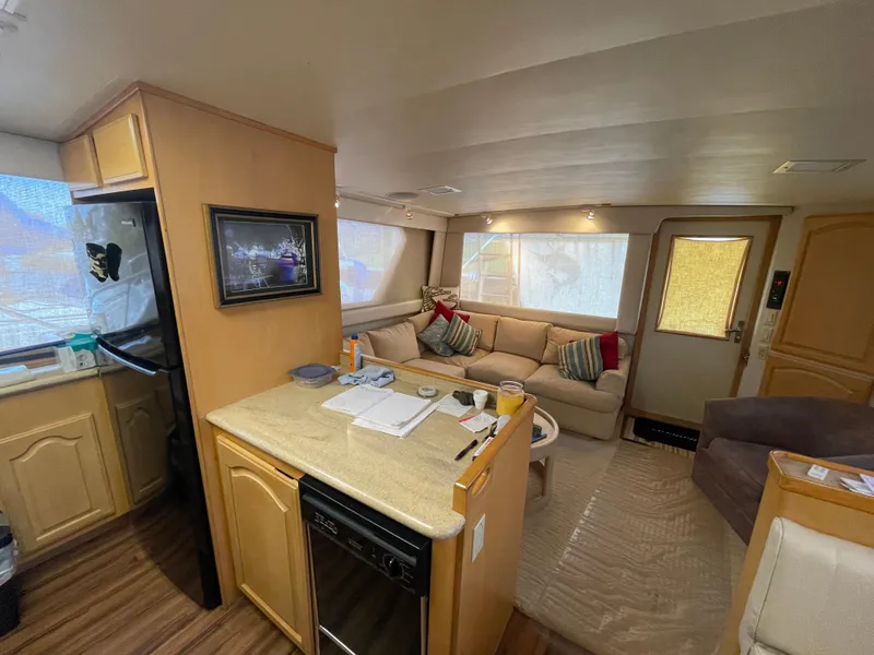 Slide: The Image of Interior of 1988 Hatteras 55 Convertible yacht with cozy seating and modern kitchen. - 31