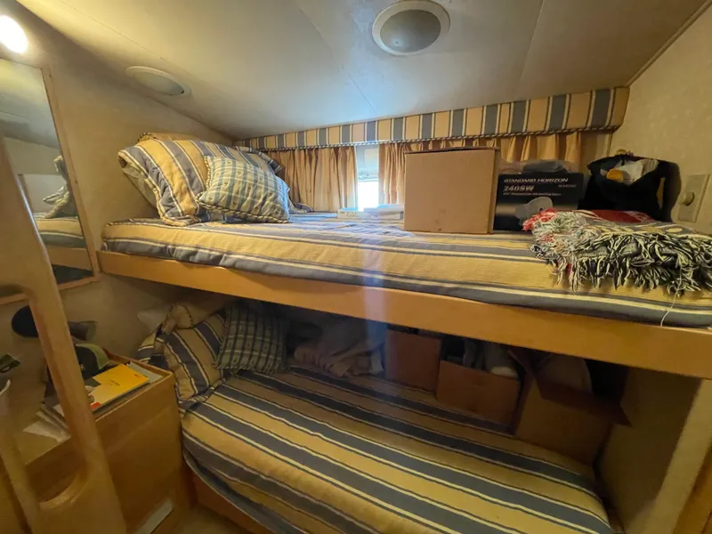 Slide: The Image of Bunk beds in 1988 Hatteras 55 Convertible yacht cabin with striped bedding. - 33