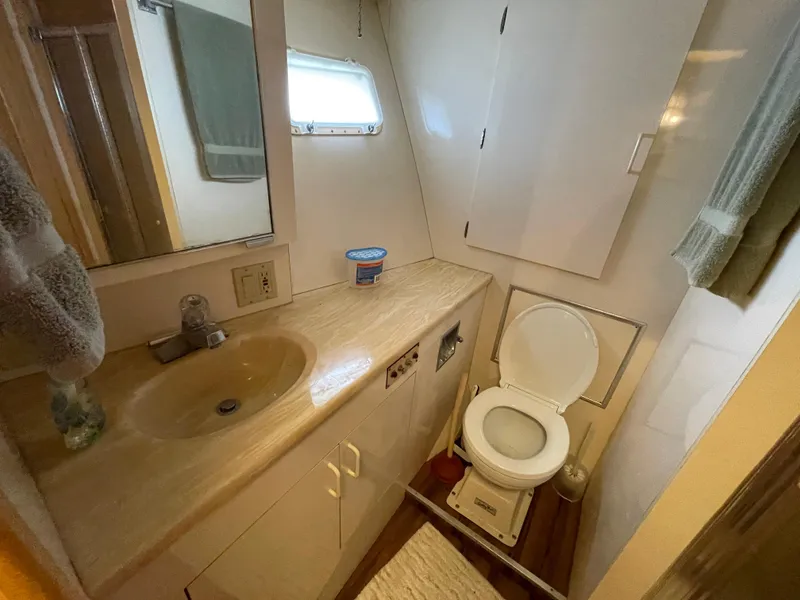 Slide: The Image of Bathroom interior of 1988 Hatteras 55 Convertible yacht, featuring sink and toilet. - 35