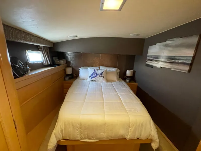 Slide: The Image of Cozy bedroom interior of 1988 Hatteras 55 Convertible yacht with nautical decor. - 36