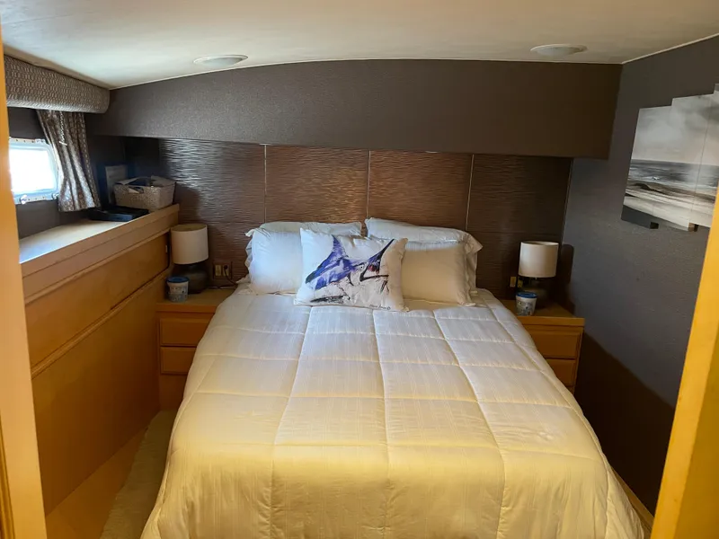 Slide: The Image of Cozy bedroom interior of 1988 Hatteras 55 Convertible yacht with elegant bedding and decor. - 37