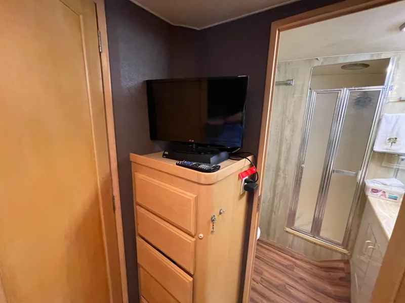 Slide: The Image of Interior of 1988 Hatteras 55 Convertible with TV, dresser, and bathroom. - 39