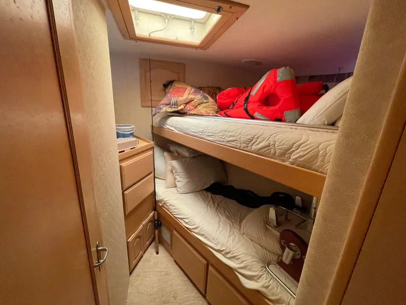 Slide: The Image of Bunk beds in 1988 Hatteras 55 Convertible cabin with life jackets and storage. - 41