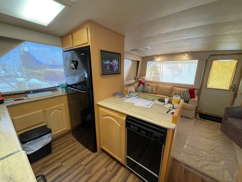 Slide: The Image of Interior of 1988 Hatteras 55 Convertible yacht with kitchen and seating area. - 43