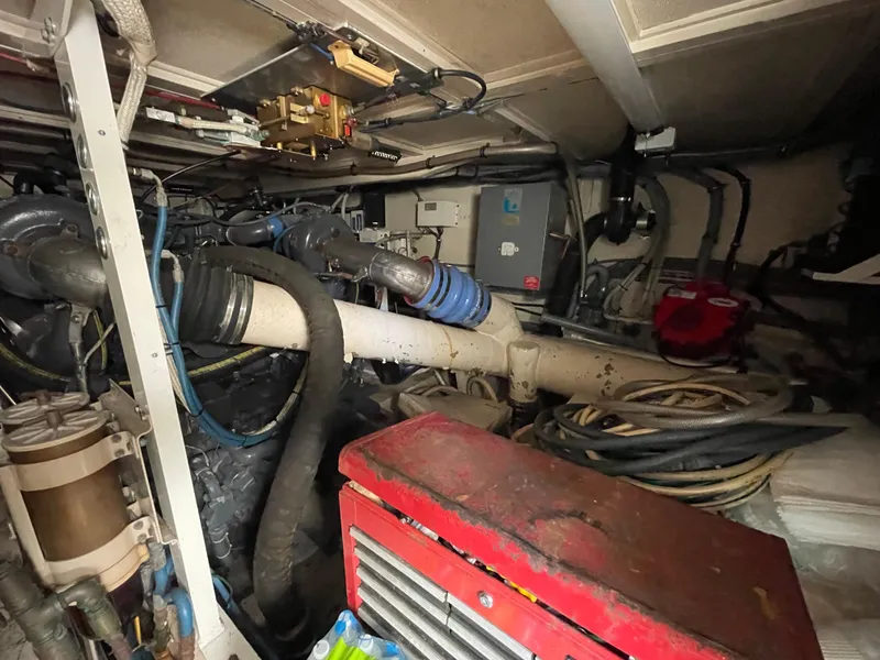 Slide: The Image of Engine room of a 1988 Hatteras 55 Convertible yacht with visible machinery and equipment. - 45