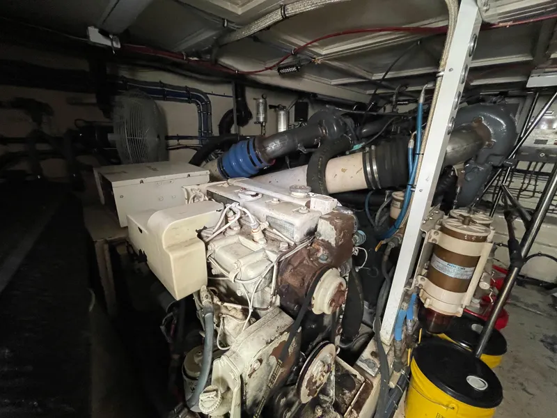 Slide: The Image of Engine room of a 1988 Hatteras 55 Convertible yacht, showcasing machinery and components. - 46